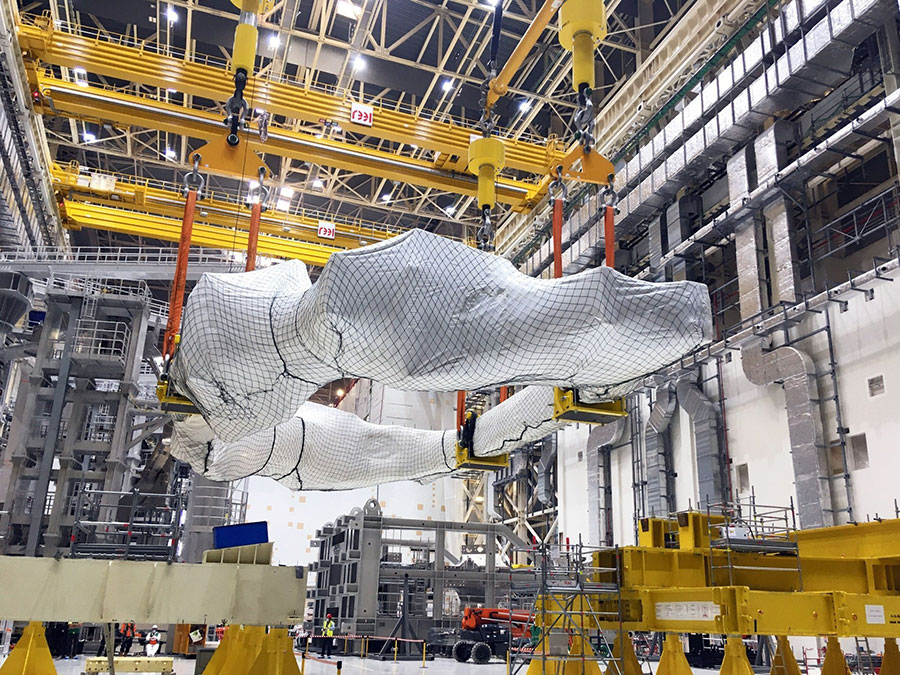 One of the 18 toroidal field coils is changing storage frames in the Assembly Hall.